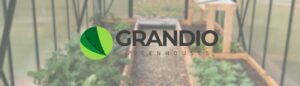 Grandio Greenhouse logo with a greenhouse kit background